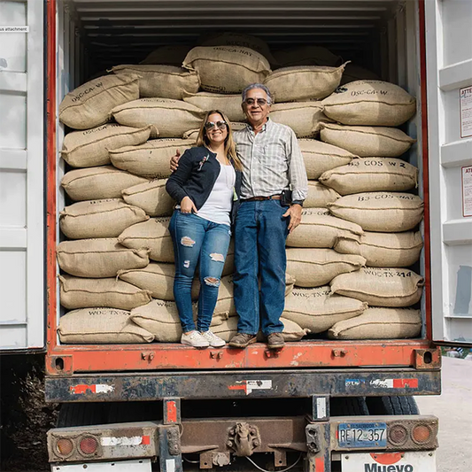 Two coffee farmers in the back of a truck